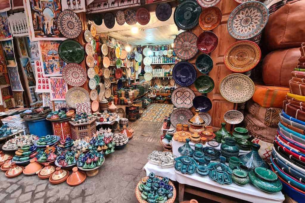 A stall selling pottery, tagines, rugs and artwork in a medina in  Marrakesh. Bartering in colourful souks is a tradition in Morocco.