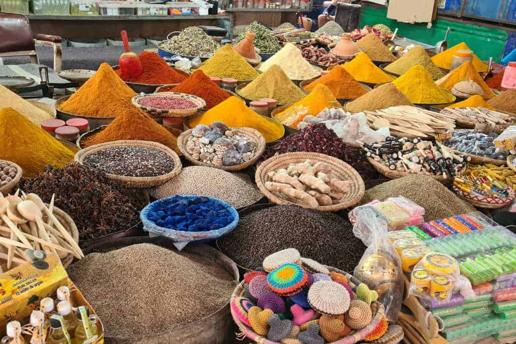 Colourful spices piled up in dishes to sell at a Moroccan Market.