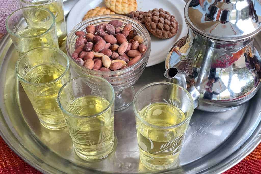 A tray with teapot, glasses of mint tea and nuts which is a traditional Moroccan welcoming.