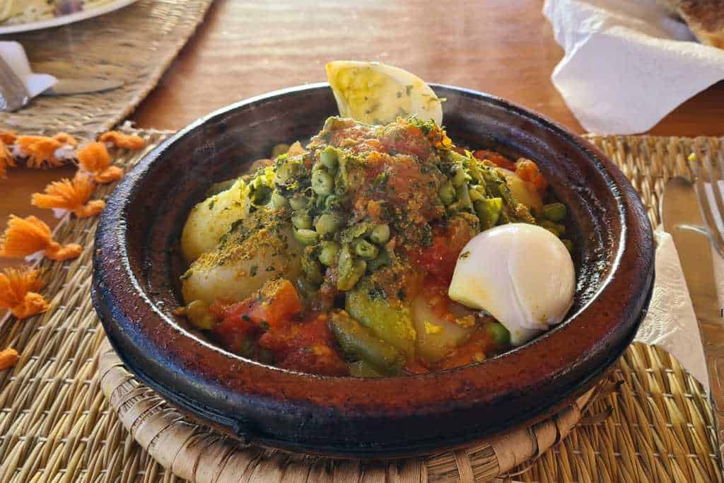 A steaming hot bowl of vegetables cooked in a traditional Moroccan tagine. 