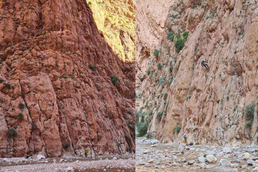 A tall rocky gorge making and river bed with rock climbers on the wall in Todra Gorge Morocco. 