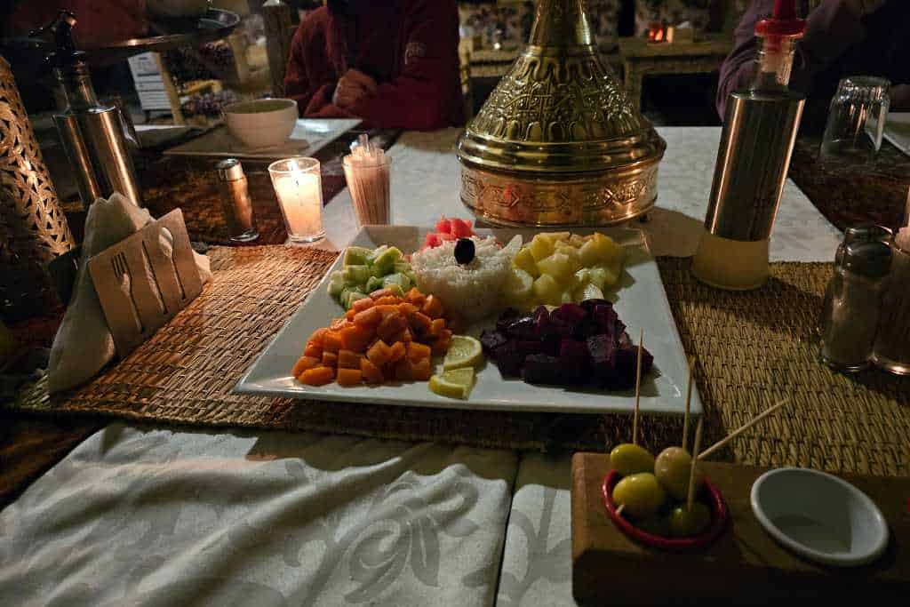 A table set out with dinner in a tent. Traditional Moroccan food served for families in the Sahara.