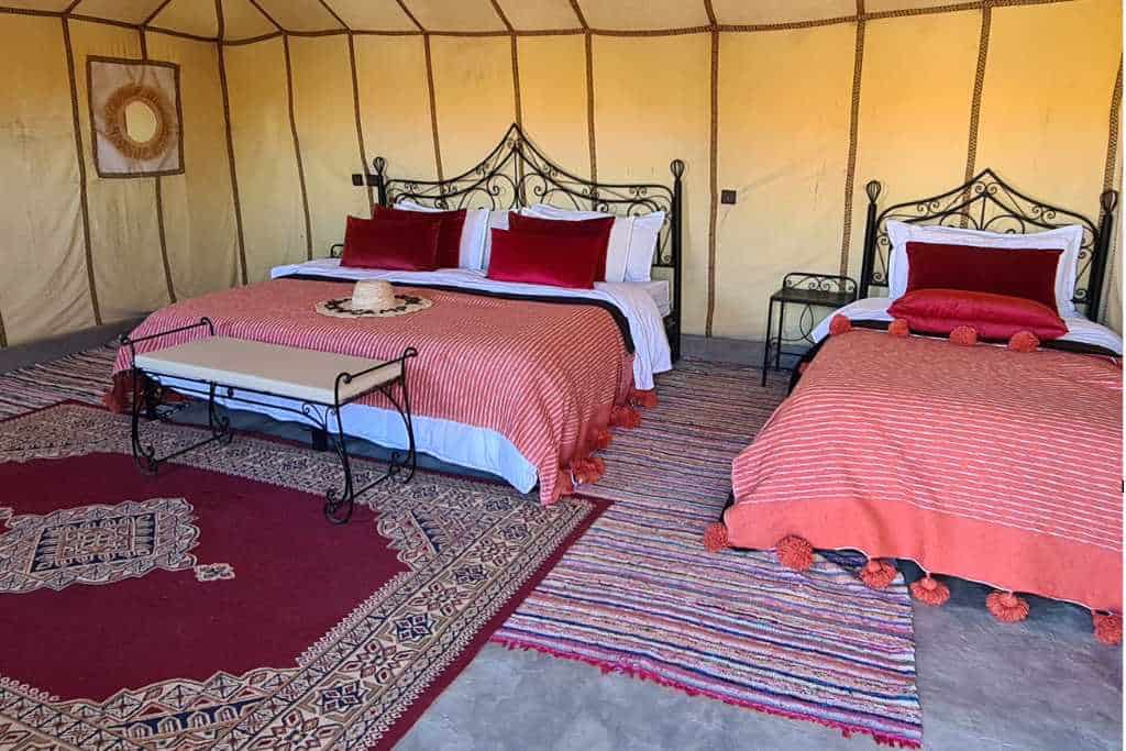 Accommodation for three people inside a luxury desert camp in the Sahara desert in Morocco.