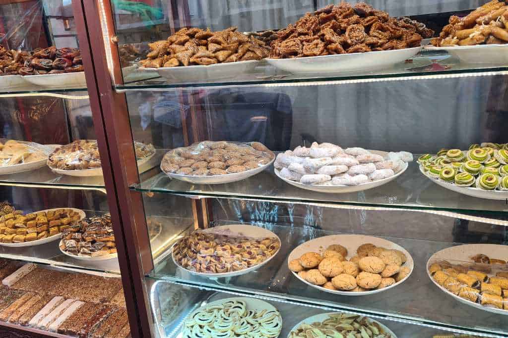 A glass cabinet with different traditional sweets to buy in Morocco.