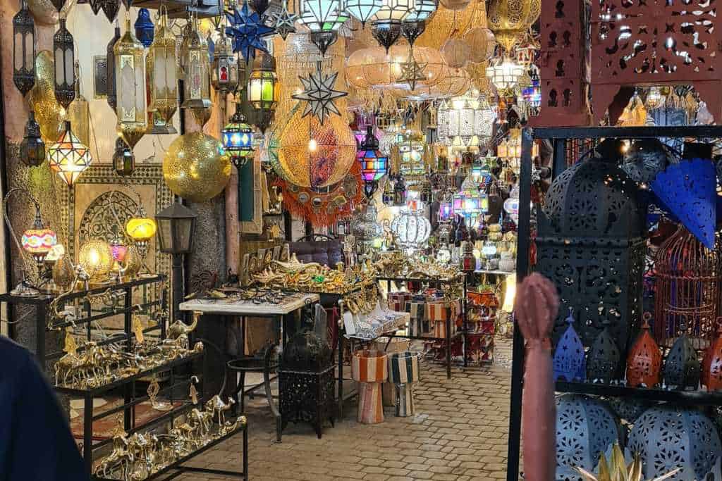 A market stall with lanterns and metal ornaments for sale.