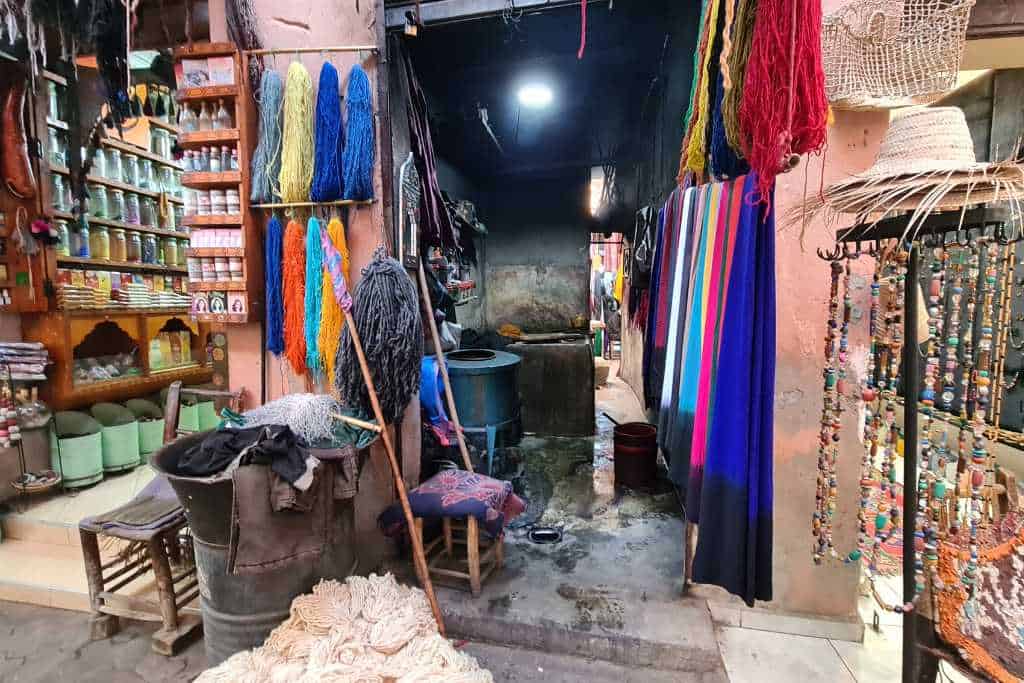 Colourful scarfs hung in an alleyway. A popular gift to buy from a souk in Morocco.